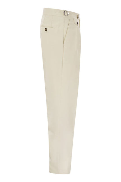 Tailor-fit trousers in cotton gabardine and virgin wool with double inverted darts and buckles on the side