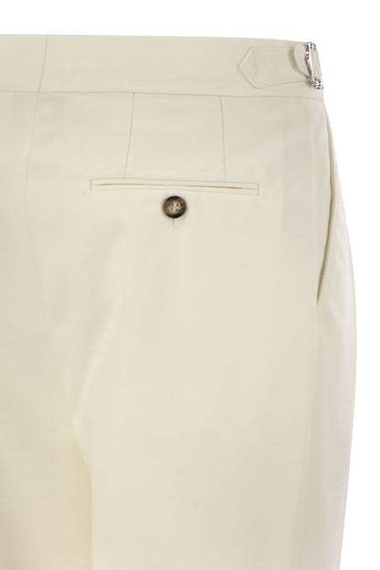 Tailor-fit trousers in cotton gabardine and virgin wool with double inverted darts and buckles on the side