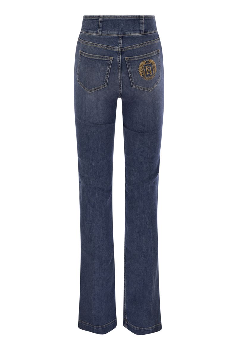 Stretch cotton flared jeans with central button placket