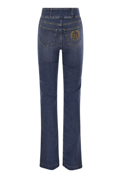 Stretch cotton flared jeans with central button placket