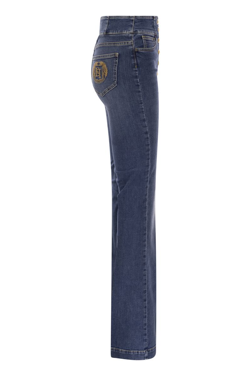 Stretch cotton flared jeans with central button placket