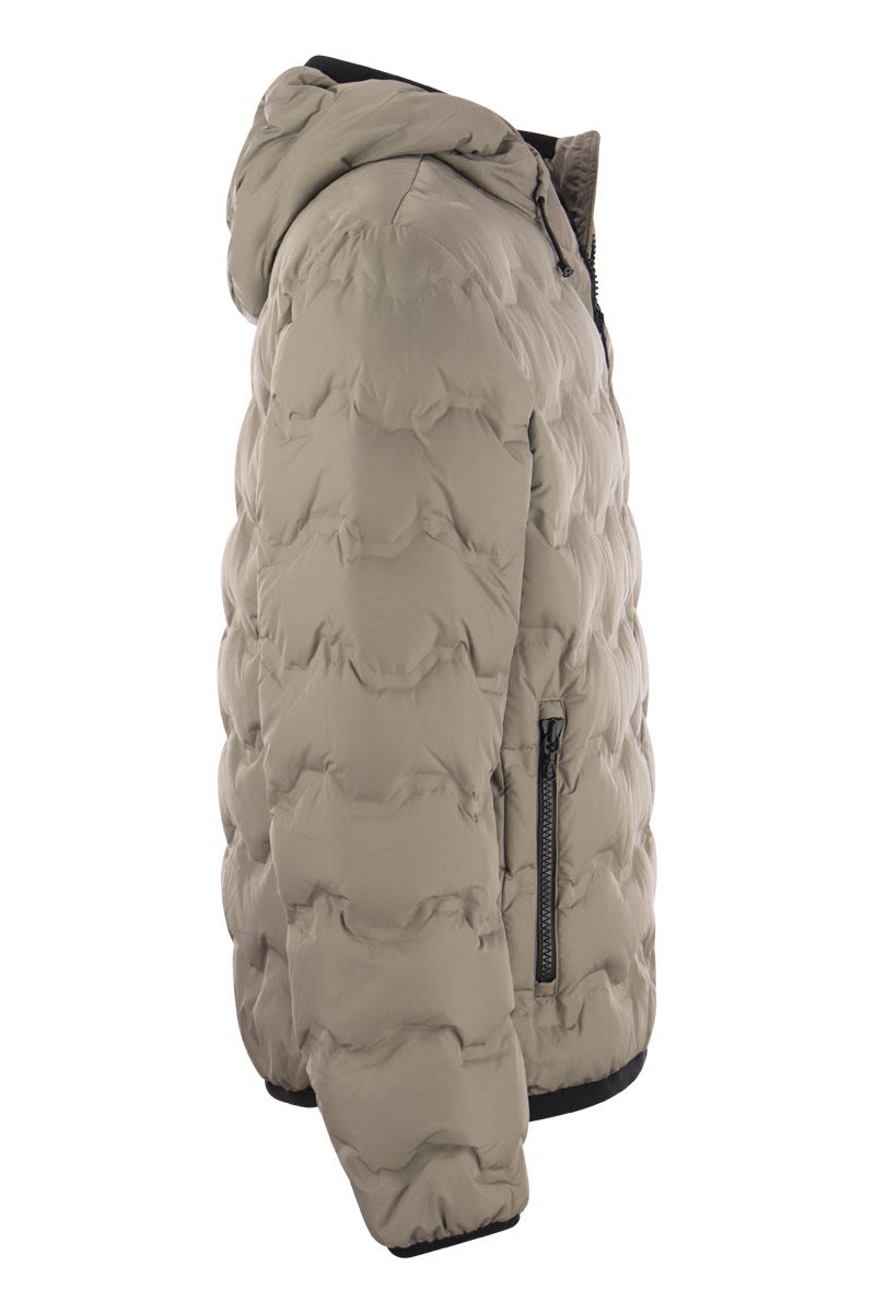 UNCOMMON - Quilted down jacket with hood - VOGUERINI