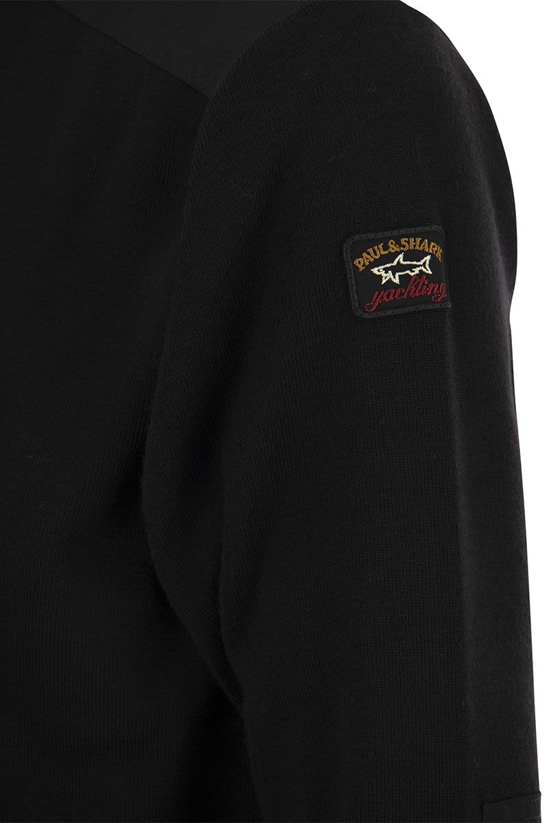 Wool crew neck with iconic badge - VOGUERINI