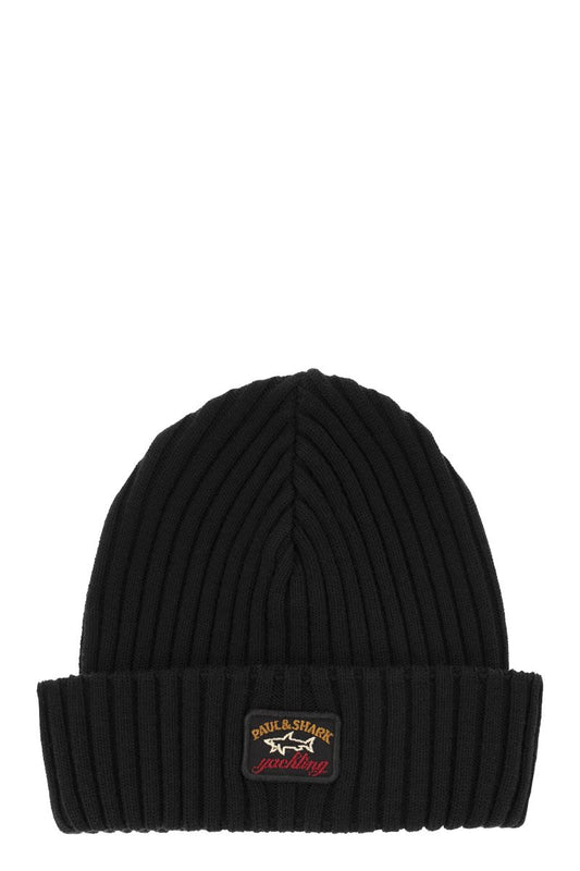 Iconic coin badge ribbed wool hat - VOGUERINI