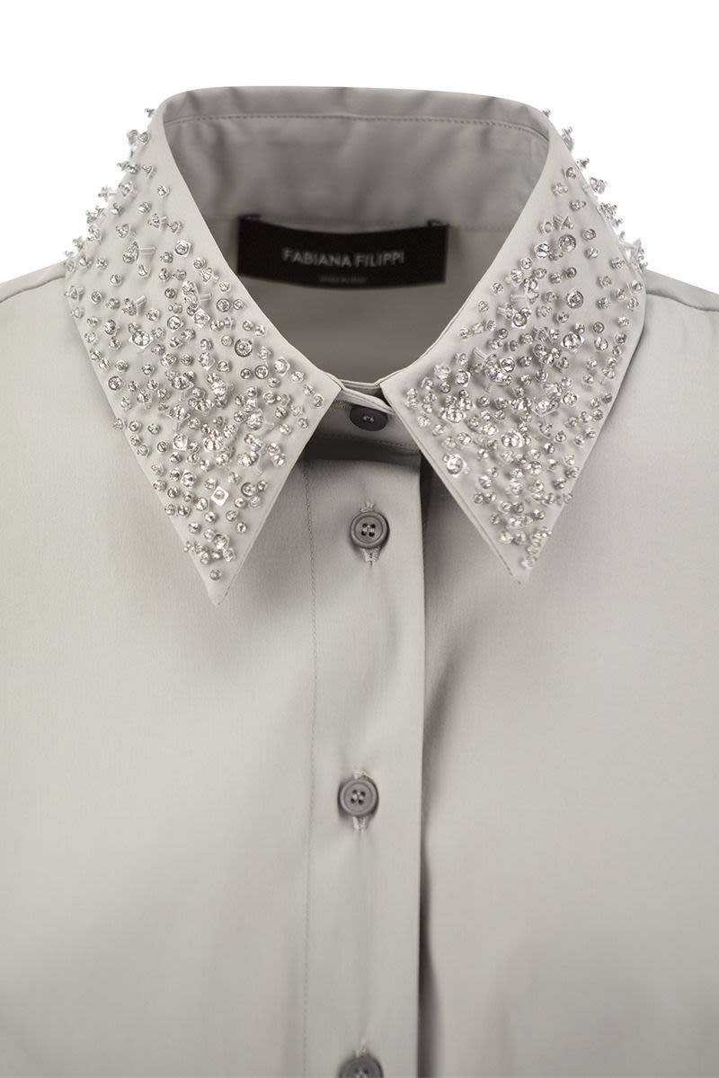 Sleeveless shirt with belt - VOGUERINI