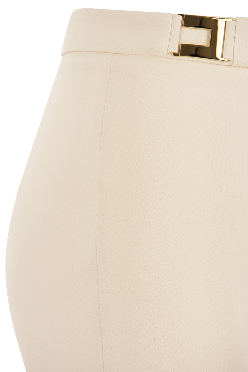 Straight crepe trousers with logo plaques - VOGUERINI