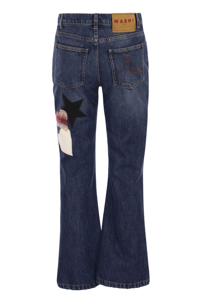 Denim flare trousers with knitted appliqués - VOGUERINI