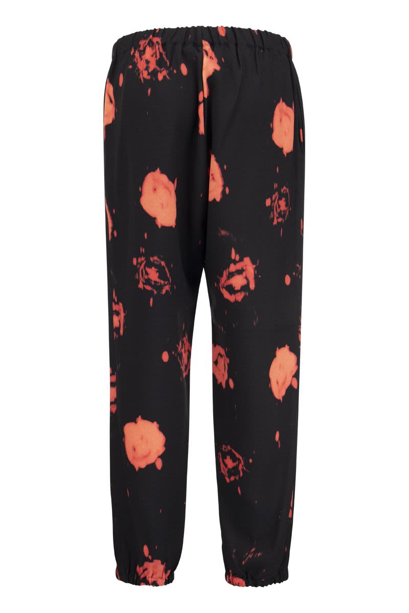 Trousers with Faded Roses print - VOGUERINI