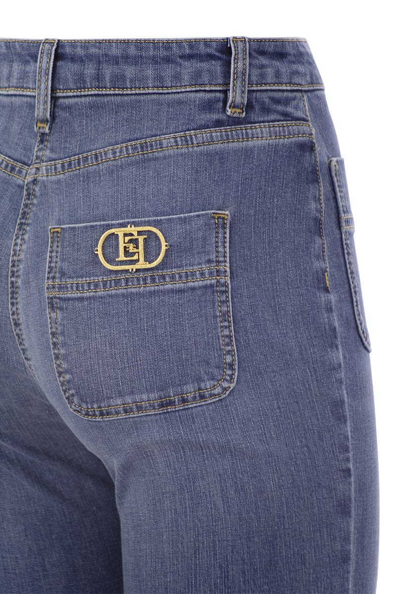 Paw jeans with logo plates - VOGUERINI